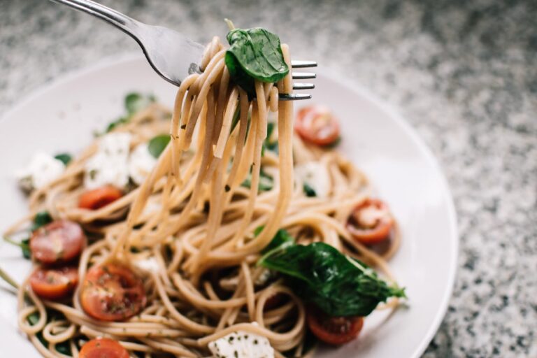 a fork on a plate of pasta